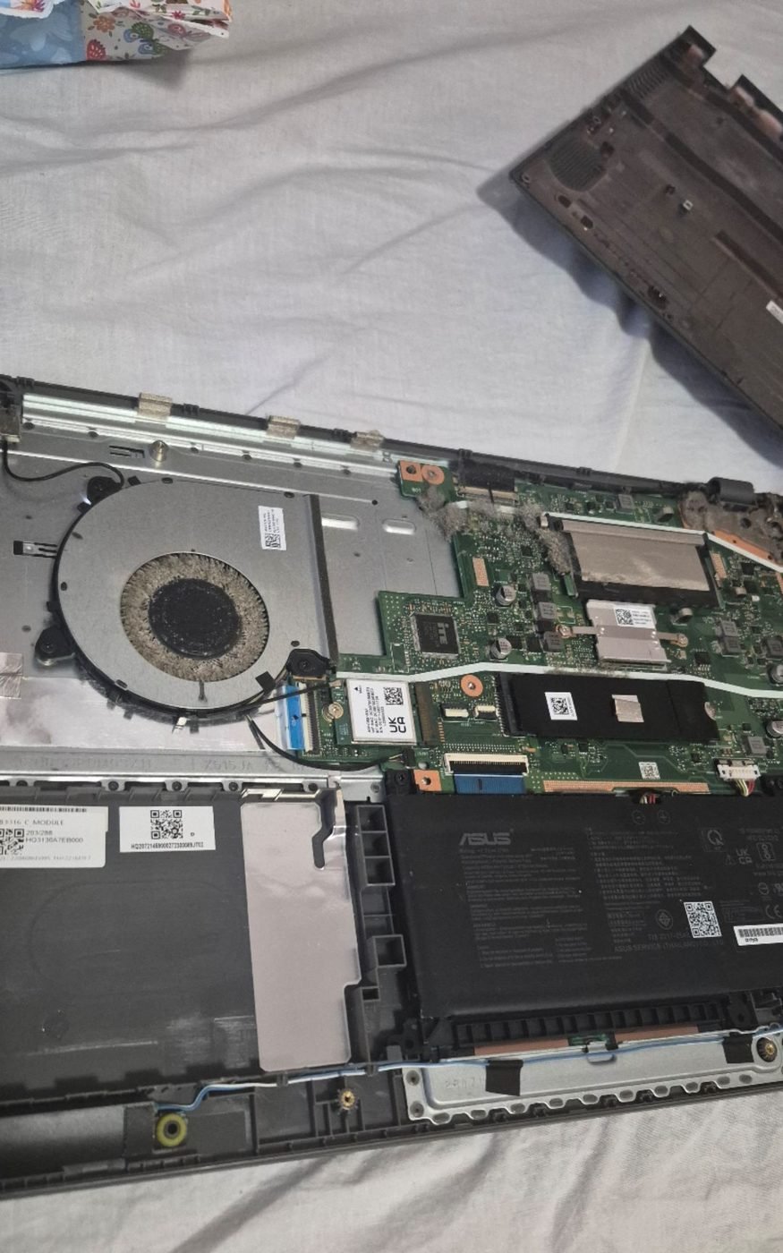 Laptop ASUS desfăcut pe masa de lucru, înainte de curățare și schimbarea pastei termice